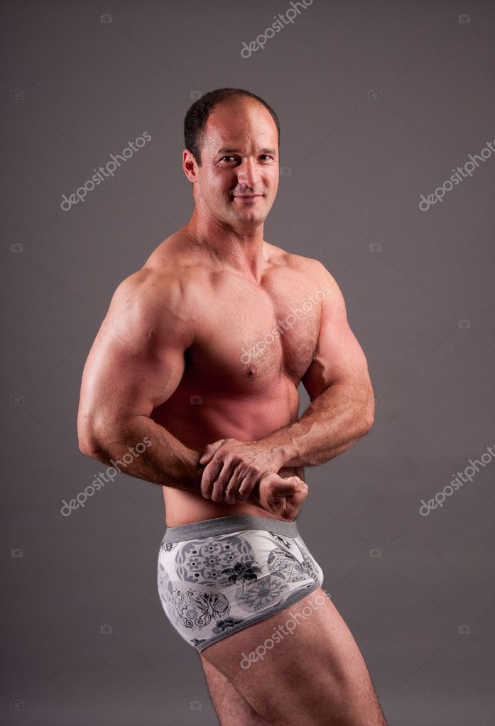 Mature bodybuilder posing in studio