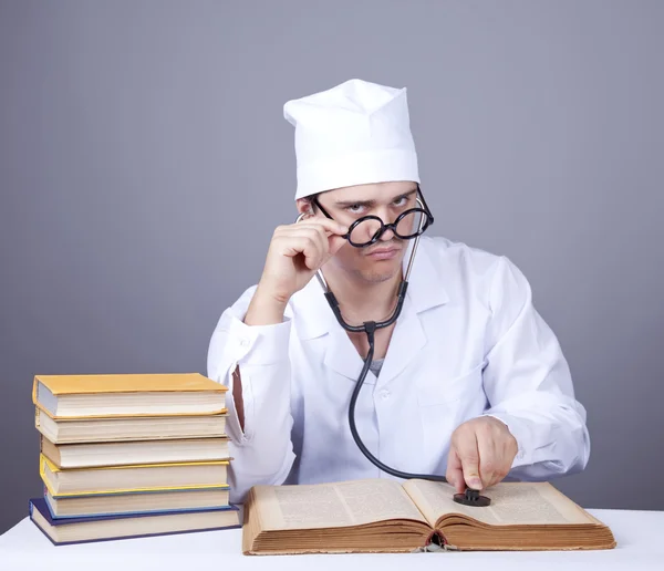Young doctor with books and computer. — Stock Photo #4337078