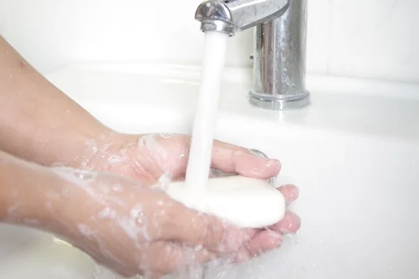 Hands being washed with soap