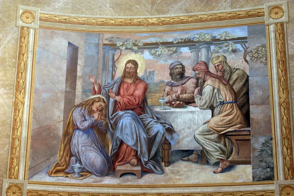 Saint Mary Magdalene wipes the feet of Jesus