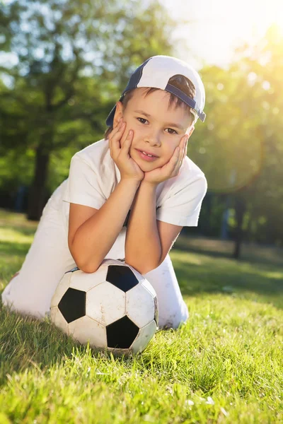Cute little boy with a ball in beautiful park in nature;