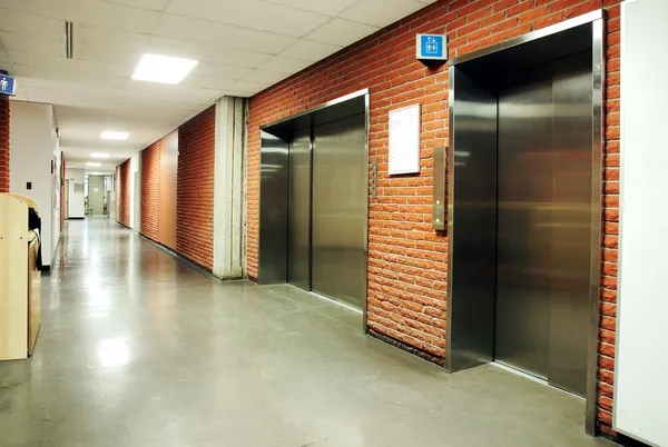 Steel door elevators in deserted hallway