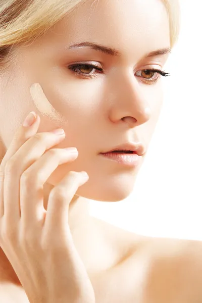 Cosmetology & cosmetic. Woman applying face skin foundation