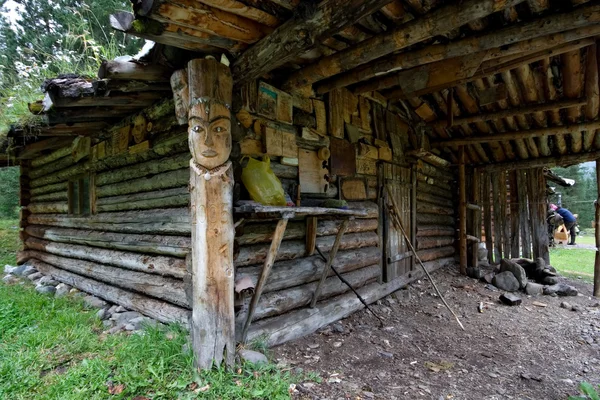 Wood hut in taiga with national symbols and images