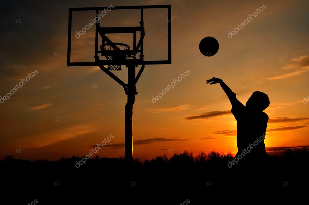 Silhouette of Teen Boy shooting a Basketball — Stock Photo ...