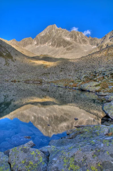 Mountain reflecting in a tarn (alpine lake)