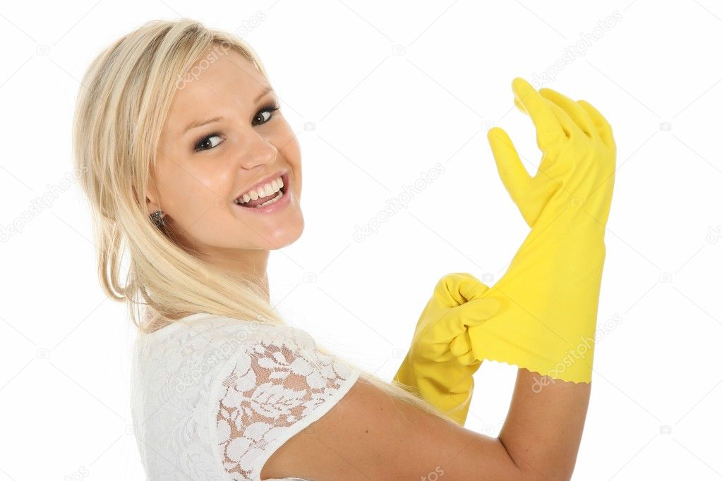 Beautiful blonde housewife putting on yellow latex cleaning gloves