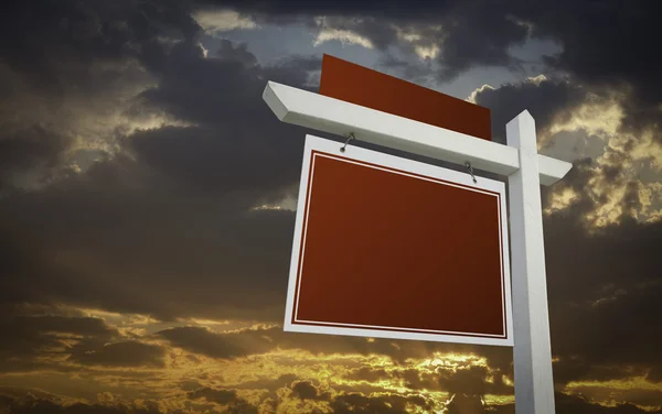 Blank Red Real Estate Sign Over Sunset Sky
