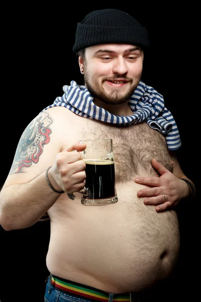 Drunk sailor man with mug of dark beer
