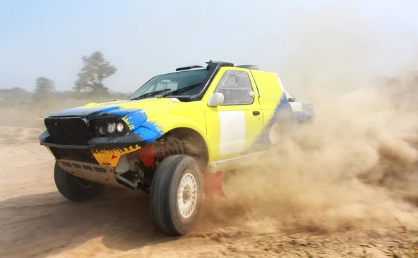 Power yellow off-road car on dirt road