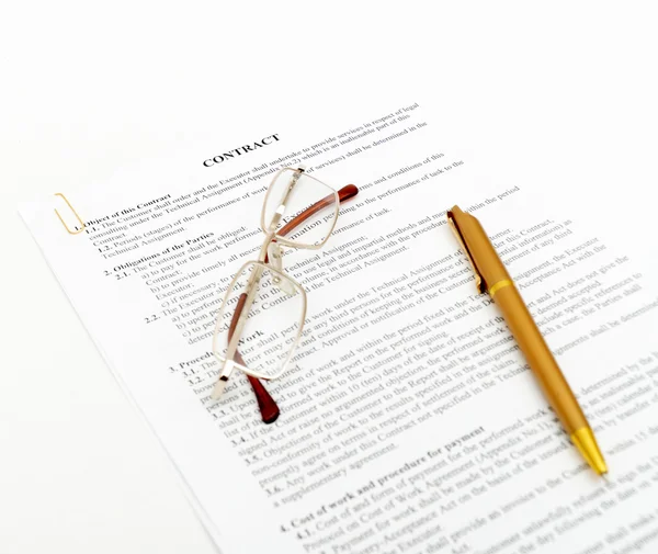 Legal contract with pen and glasses