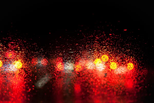 Blurred car lights in the rain