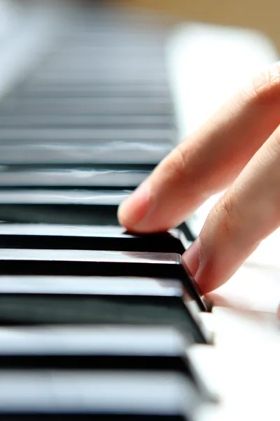Close up of the hands of a young man playing piano