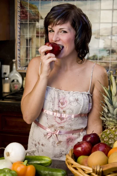 Woman taking a bite out of an apple