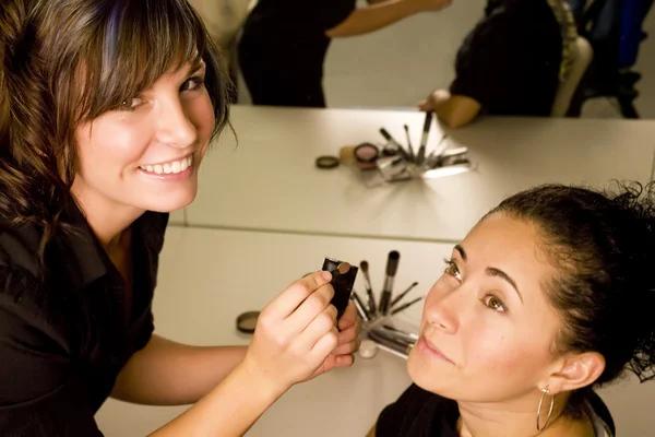 Young make up artist applying make up