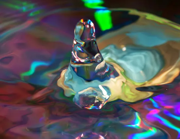Water drop on a multi-coloured background