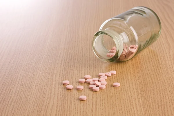 Pills on wooden background
