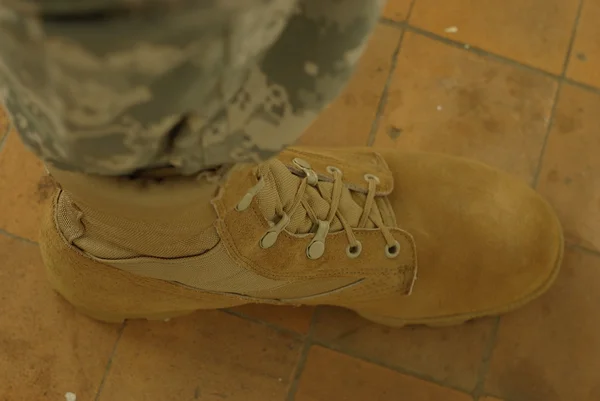 Foot in army boot