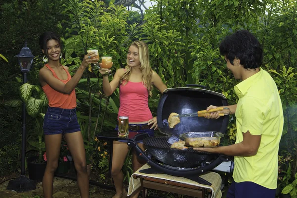 Three friends at a barbecue party in hawaii