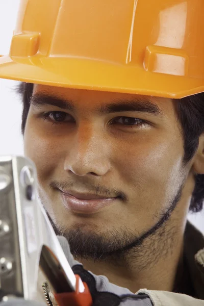 Hard hat worker with a rivet tool