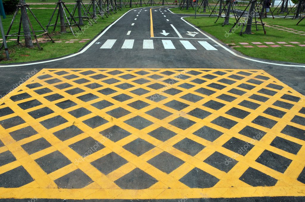 yellow-cross-line-area-on-the-road-surface-stock-photo-meawpong2008