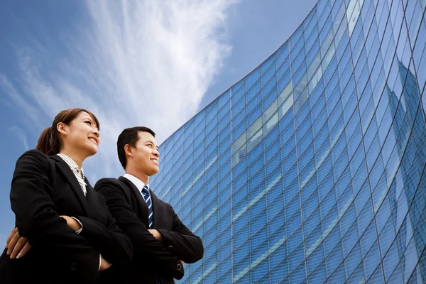 Business team standing together in front of modern building