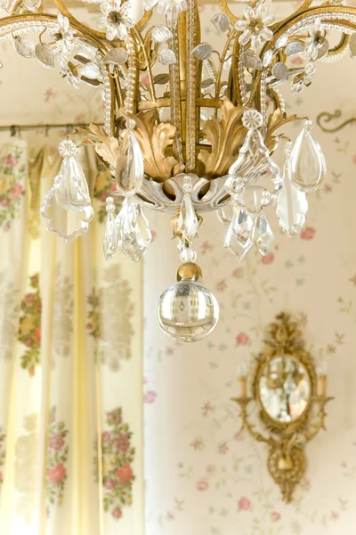 Chandelier and sconce on the wall