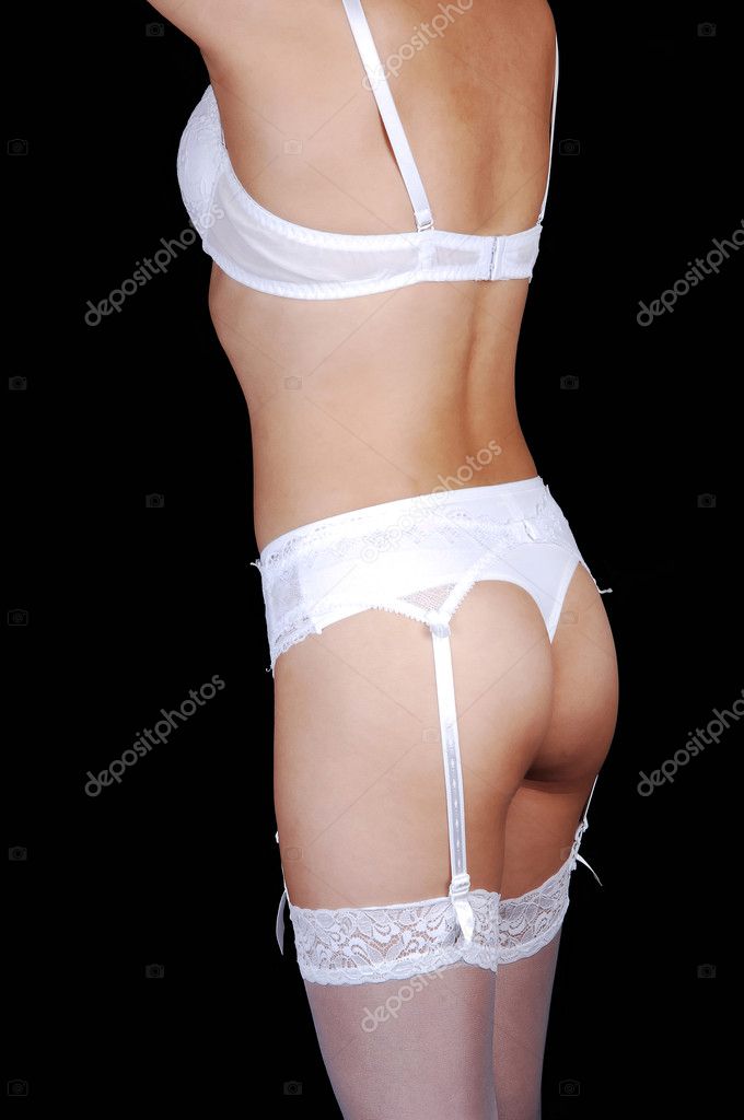  and a garter belt with white stockingsstanding for black background 