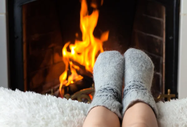 Children\'s feet are heated in the fireplace