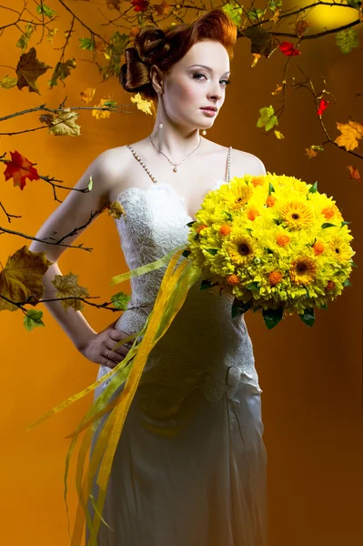 Beautiful redhead bride with a bouquet of flowers