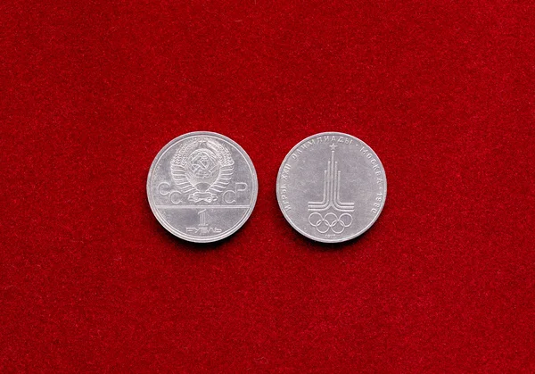 Old soviet ruble coin with symbol of 22 Olympic Game on red velvety backgr