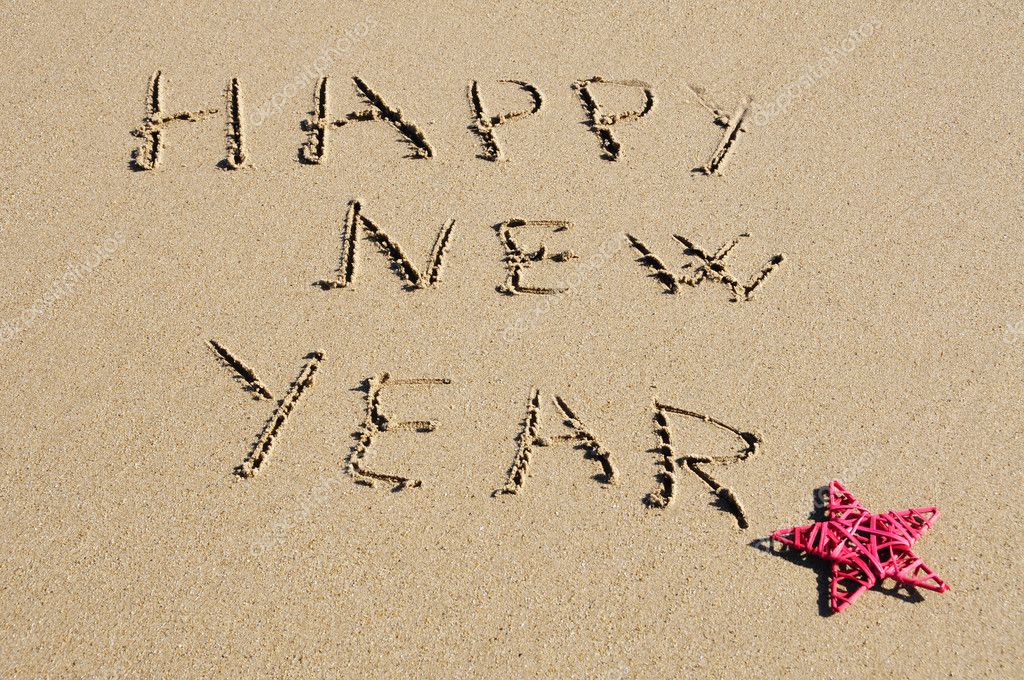 sentence happy new year written in the sand stock photo sentence happy new year written in the sand stock photo
