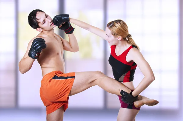 Woman fighter punching man in head
