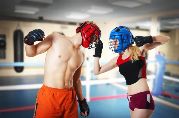 Two person training kickboxing on ring