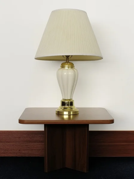 Old desk lamp on wooden table