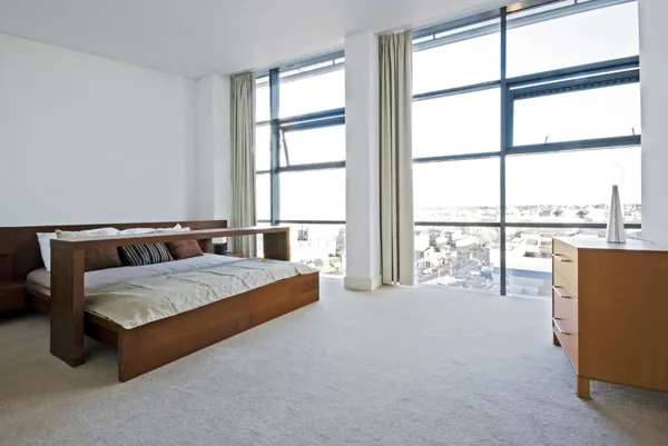 Luxury bedroom with floor to ceiling windows