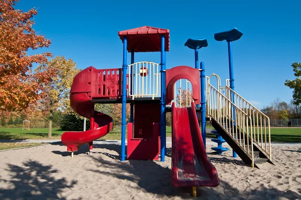 Park with Playground Equipment in Autumn
