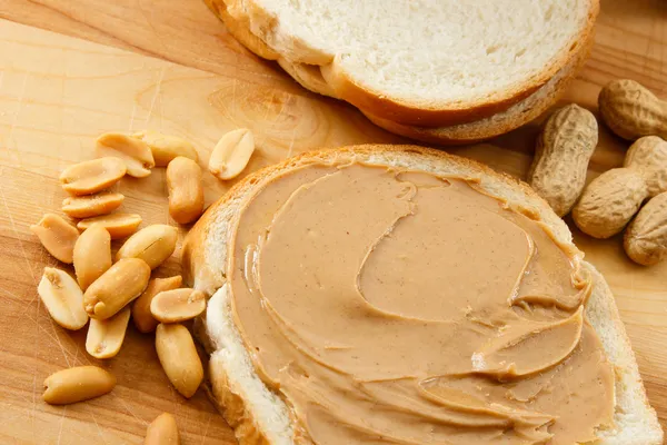 Peanut Butter on Bread with Peanuts — Stock Photo #4964126