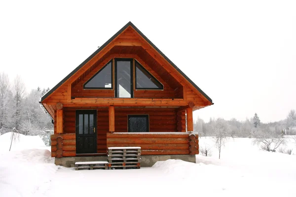 Wooden cottage in a snowy place