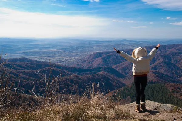 Young blonde teen on mountain top by Cezar Buliga Stock Photo