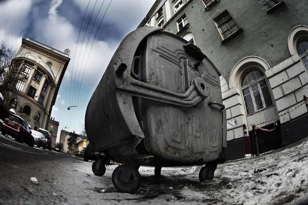 Scary old rusty trashcan in dark dirty city street