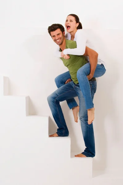 Man climbing the stairs with woman