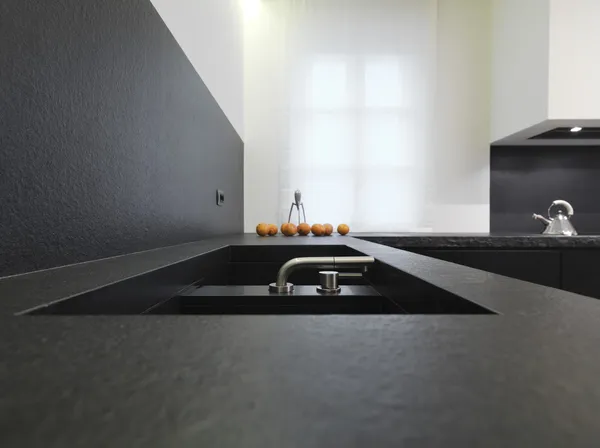 Steel faucet for a black marble sink