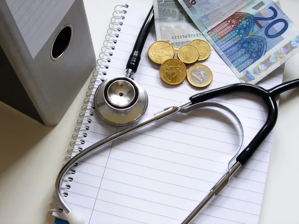 Health care & medical costs. Stethoscope & money.
