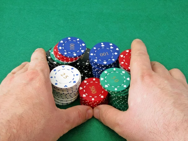 Stack of poker chips being pushed 'all in'