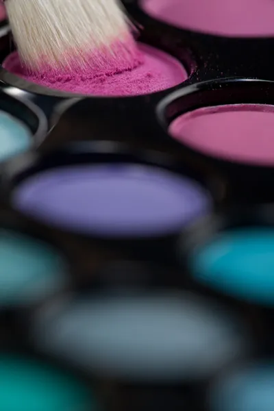 eyeshadow set with makeup brush picking up color