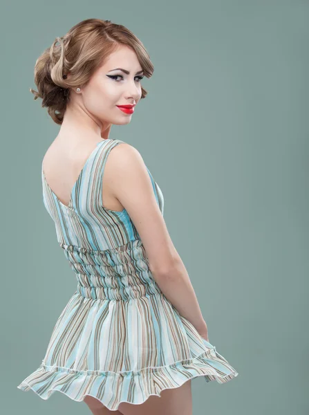 Beauty portrait of young woman wearing a mini dress, twirling, s