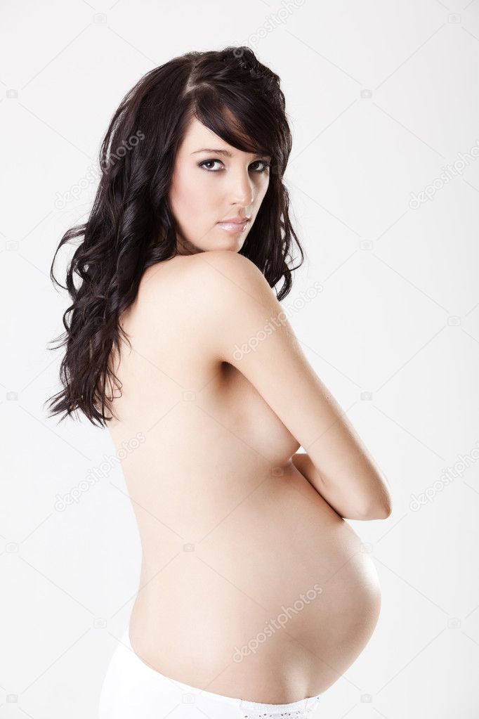 Close up of a nude pregnant body from profile isolated