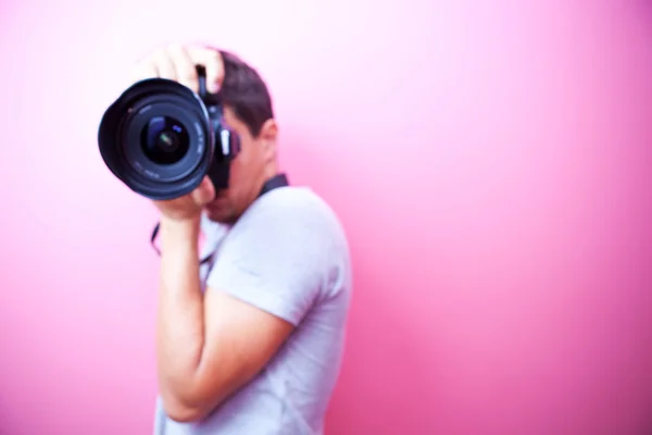 Young and handsome photographer pointing his super wide lens at — Stock Photo #5246506