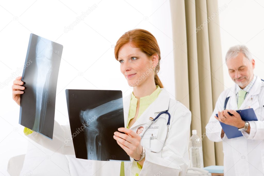 Medical team female doctor with xray in hospital man in background
